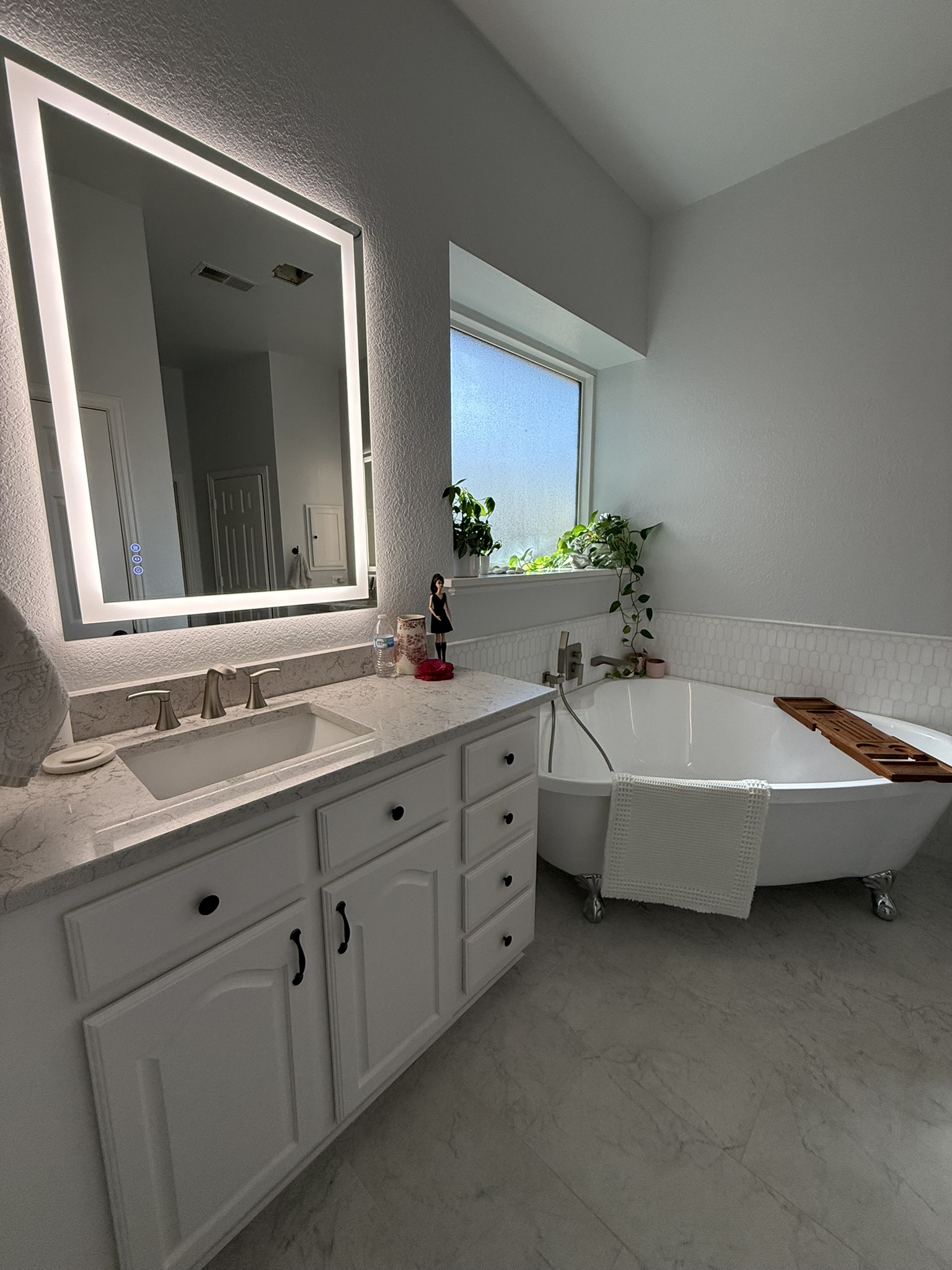 White marble tile shower with herringbone floor